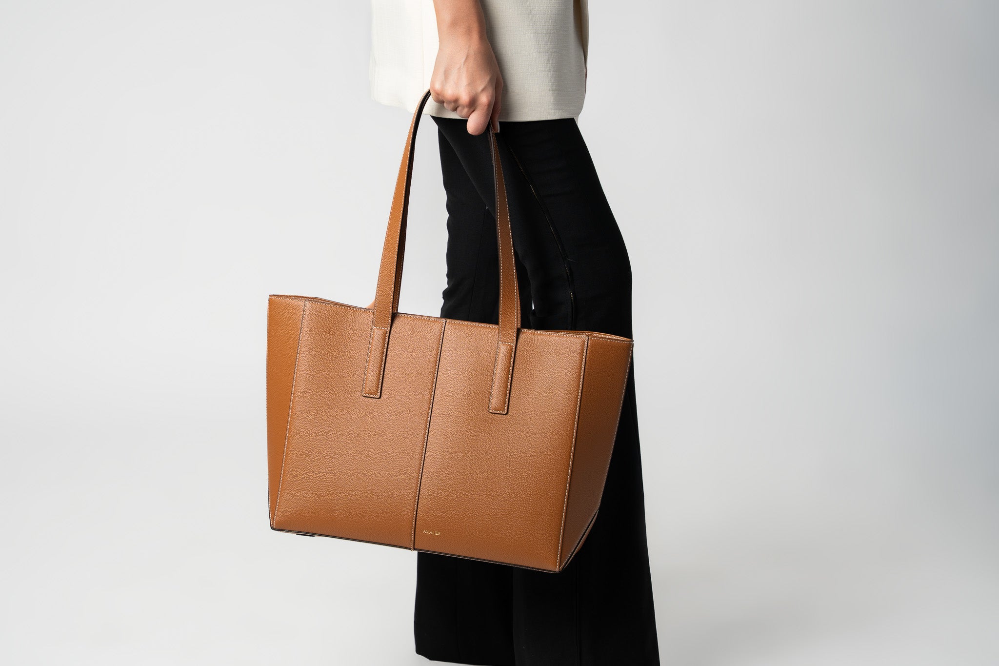 Bottom half of a model holding camel daely tote