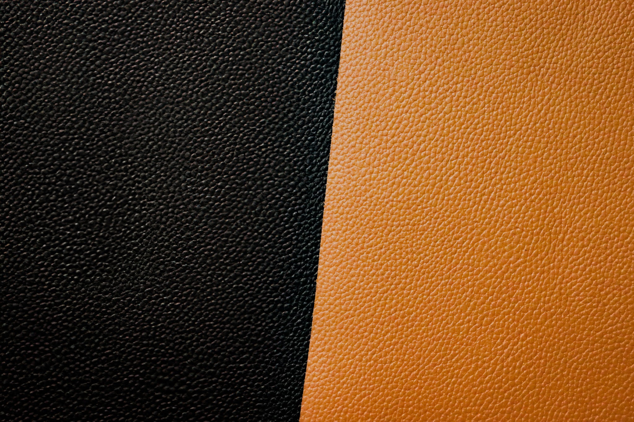 Close-up of black and brown leather textures side by side